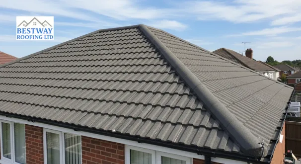 A neatly aligned concrete tile roof on a residential home, highlighting an affordable, durable, and weather-resistant roofing solution.
