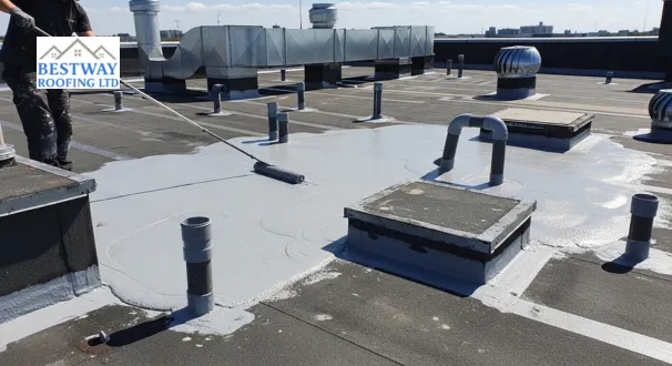 Grey liquid waterproofing curing into a smooth, joint-free membrane around roof vents, showing an ideal solution for intricate roofing shapes.
