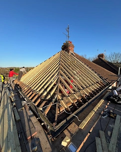 Installation of new timber rafters and "hips" (the slanted ridges) to ensure the structural integrity of the roof.