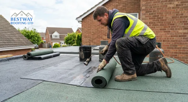 A skilled roofing contractor applies a durable, traditional torch-on felt roofing membrane to a modern residential extension
